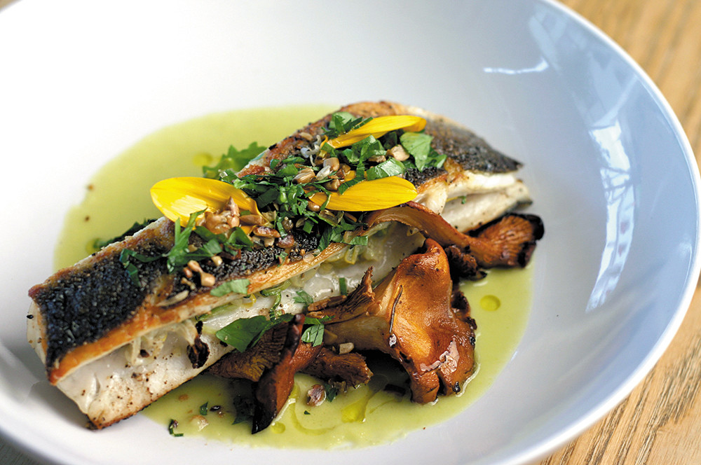 Roasted Branzino with chanterelles, kale sprouts and 
sunflower gremolata