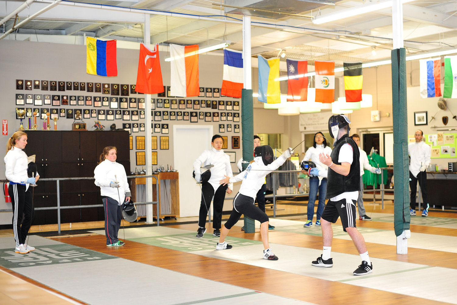 Fencers sparring during a pre-COVID lesson; RIFAC currently welcomes students with all precautions in place