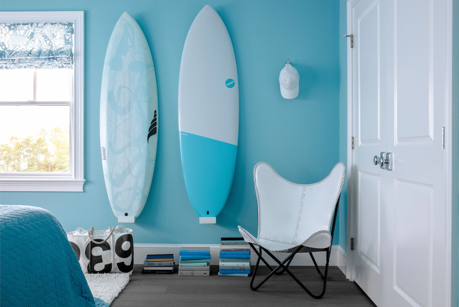 Ocean State surf culture was the inspo for the aqua guest bedroom, while accents in black and white keep the look grounded
