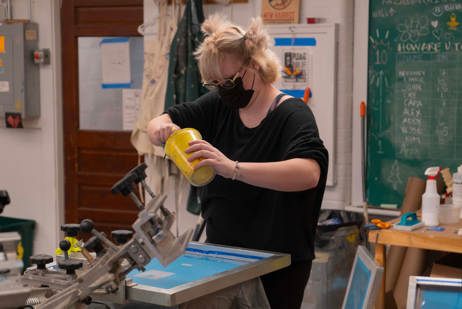 Riverzedge student Cay mixing ink for a screenprinting project