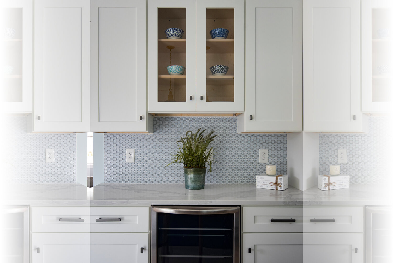Glass-front upper cabinets create depth; colorful bowls connect to the various blues