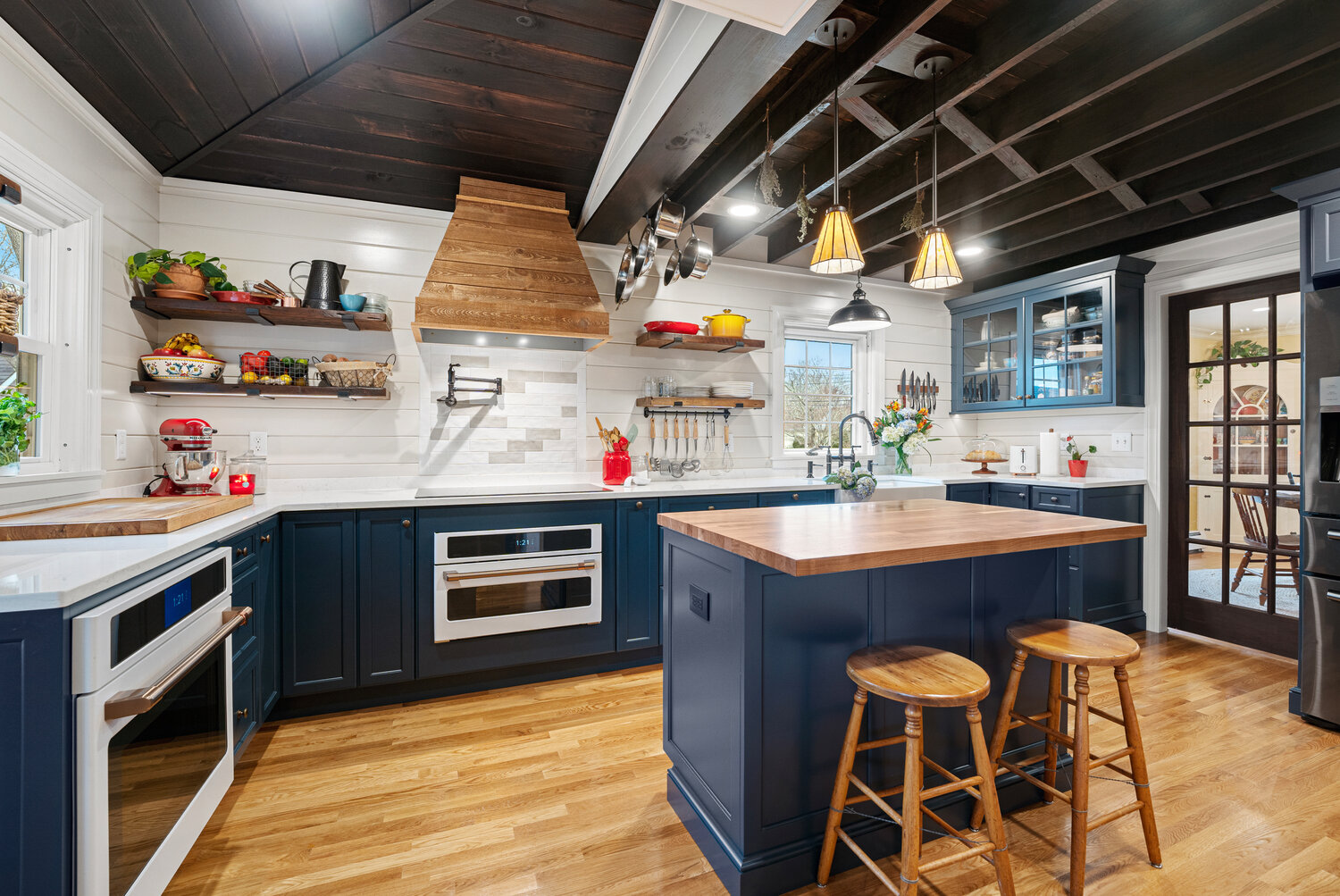 Refinished original beams create nooks to hang drying herbs and cookware