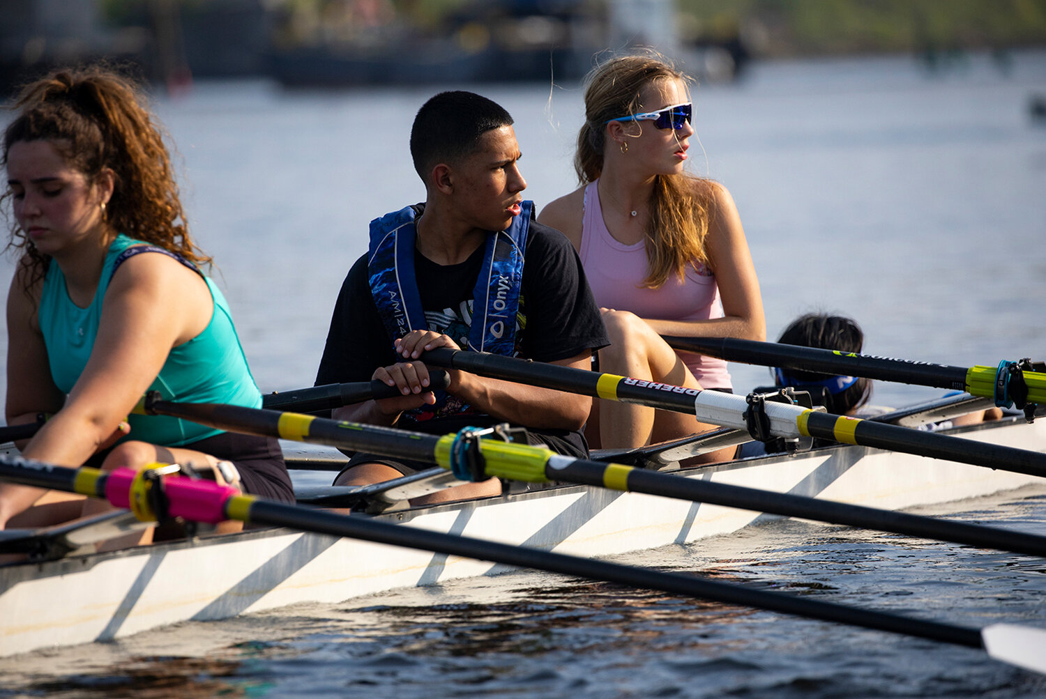 Dante Antonelli (center) is among the many middle school students that learn to row with STEM to Stern