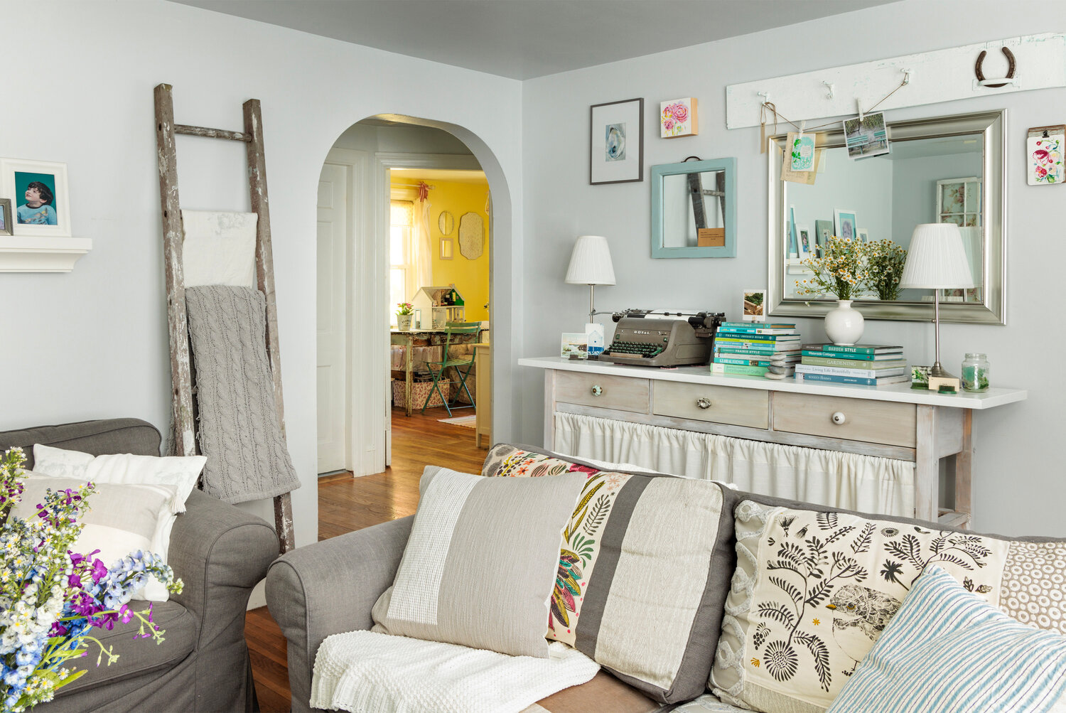 Walls are put to work with mirrors to enlarge the space, and a peg rack to hang favorite notes and cards. A ladder offers additional storage for throws and blankets