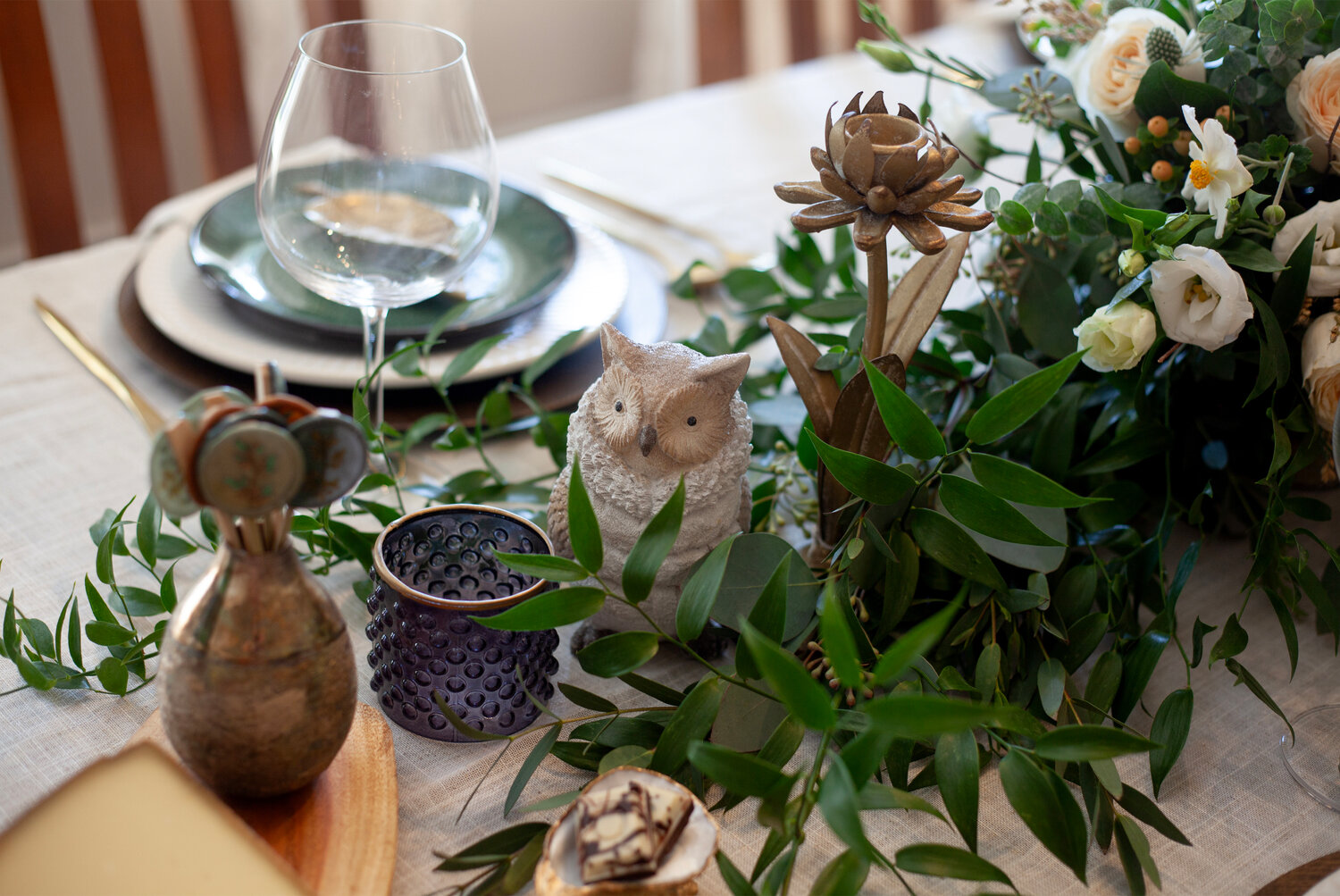 Woodland-inspired accents like candles, votives, linens, and more are evergreen pieces that can be put to use all year